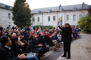 Mayor of Joigny, Bernard Moraine holds aloft the painting